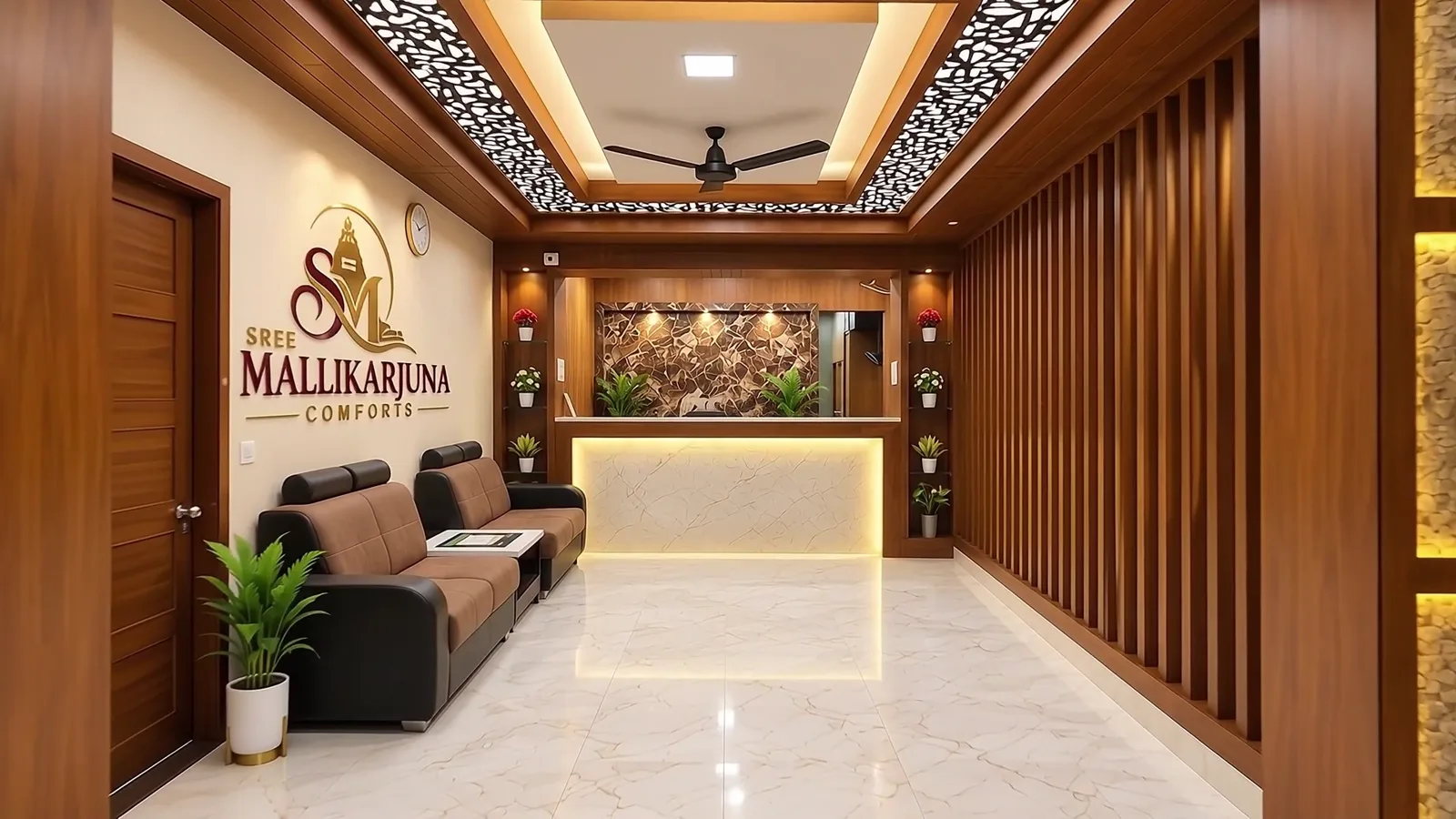 Reception lobby with the Sree Mallikarjuna Comforts logo, leather sofas and a glowing marble desk